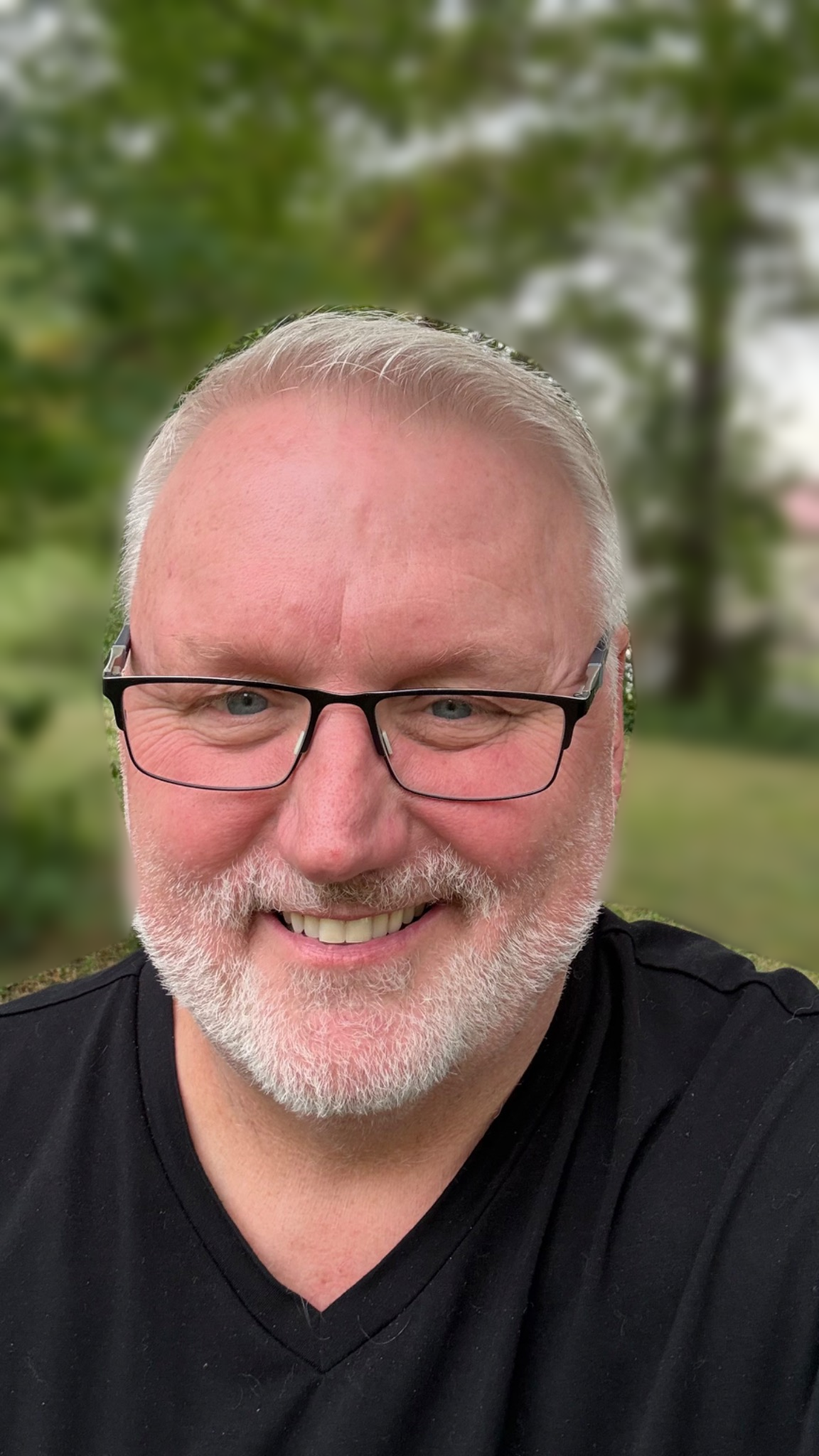 Harvey the Hair Guy smiling outdoors